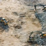 Aerial shot of heavy machinery working on a construction site in Dubai.